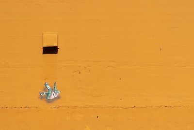 woman in white bikini lying on white sand during daytime